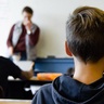 Photo of children and teacher taken from back of classroom