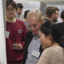 Photo of Yuyan Xue presenting her poster to Prof Stephen Levinson