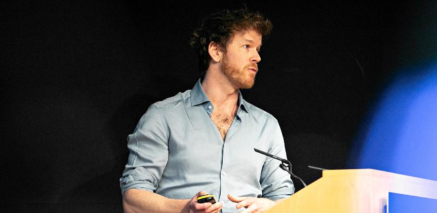 Photo of Duncan Astle talking at podium