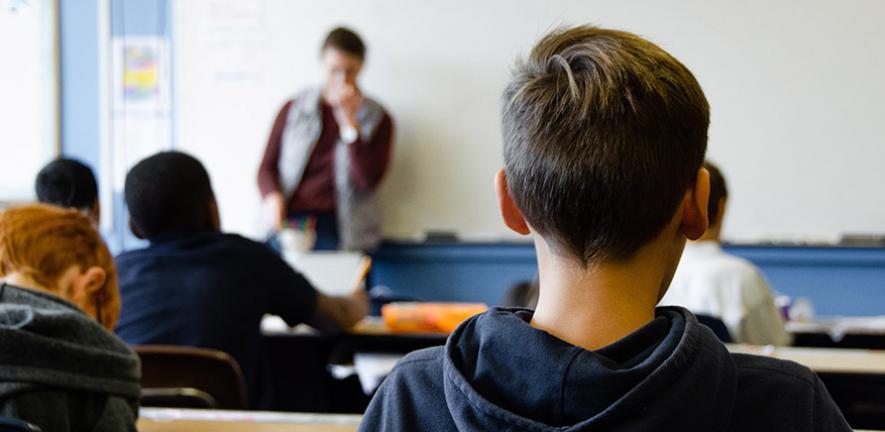 Photo of children and teacher taken from back of classroom