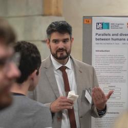 Photo of Dr Máté Aller presenting his poster at the Annual Symposium 2022